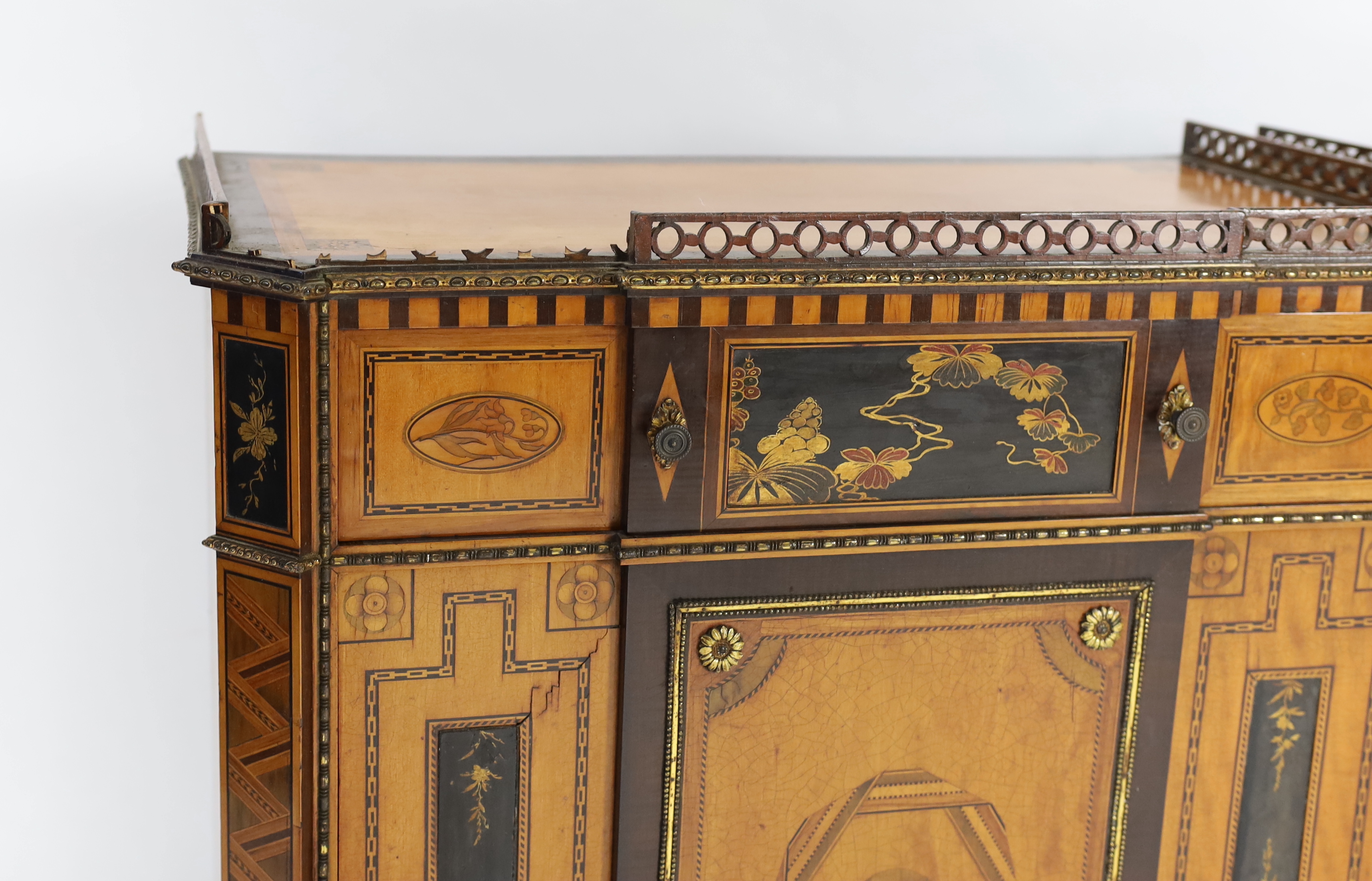 A pair of French Transitional style satinwood and marquetry side cabinets, 57cm wide, 40cm deep, 87cm high